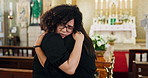 Chapel, family and sad at funeral with hug for mourning or grief, depression and support for death or mental health. People, together and ceremony or memorial for loss with comfort and unhappy sorrow