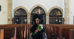 Senior woman, flowers and funeral at church with wheelchair, sad man and burial ceremony. Family, grief or help person with a disability in chapel for memorial service, death or mourning with bouquet