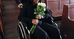 People, flowers and funeral at church with roses, wheelchair or hands at burial ceremony. Family, grief or help person with a disability in chapel for memorial service, death or mourning with bouquet
