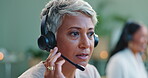 Mature woman, headset and customer service in call centre, and telemarketing for sales to leads. Advisor, talking or consultant in office at desk, negotiation or productivity client support by desk