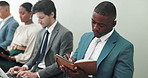 Job interview, tablet or business people in waiting room with hiring, research or online resume check at hr office. Recruitment, opportunity or men and women with digital, survey or app questionnaire