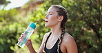 Woman, relax and exercise in nature with drinking water for hydration, tired and deep breathing with fitness. Runner, athlete or liquid break for workout, running or training outdoor for healthy body