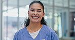 Portrait, smile  and employee in hospital for healthcare and professional, wellness and medicine. Medical, worker and female person in clinic for career in cardiology, service and girl with happiness