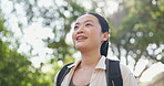 Hiking, breathing or Asian woman in a nature, park or woods for vacation, break or outdoor holiday adventure. Relax, morning or happy person in forest for fresh air for travel, trekking or wellness