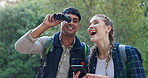 Forest, excited and adventure for couple with binoculars for watching in woods, phone and journey. Location, man and woman in relationship on date for travel in nature with mobile and technology