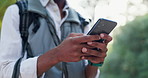 Phone, nature and closeup of man hiking in forest networking on social media, mobile app or internet. Hands, technology and person typing email on cellphone trekking in outdoor woods for adventure.