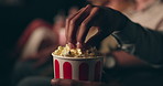 Closeup, hands and man with popcorn, cinema and movie theater with audience and snack. Eating, film treat and people with premiere and food with crowd and hungry with entertainment, relax and leisure