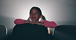 Young girl, child and smile in cinema while watching movie, happy and alone with empty chairs. Joyful, cheerful and kid in theater for film, entertainment and bright lights with seats in night time