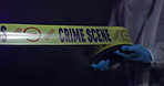 Police, hands and yellow tape for crime scene, investigation and barricade in night for warning, danger or sign. Forensic inspection, person or detective with security for robbery, murder or no entry