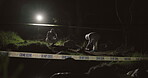 Forensic team, photographer and crime scene at night for investigation or observation with hazmat or police tape. Collaboration, expert investigator or outdoor in forest for evidence or case research