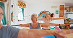 Elderly woman, plates and stretching with class for yoga or spiritual wellness together. Senior people, yogi and coaching in relax, fitness or warrior pose for awareness, zen or indoor exercise