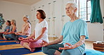 Elderly woman, zen and meditation with yoga class for spiritual wellness, breathing or inner peace. Senior group, people or yogi meditating in lotus for health, awareness or chakra together on mat