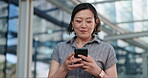 Woman, texting and commute to work, city and smartphone, conversation and technology. Happy, japanese and check email in urban area, office buildings and businesswoman for networking and chat