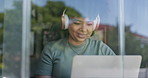 Woman, headphones and happy with laptop, remote work and streaming music for online and internet. Creative, worker and network for freelance career, copywriter and working on social media campaign