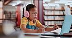 Laptop, headphones and student in library typing online for remote or distance learning on notebook. Technology, assessment and female child writing at school for elearning, studying or development