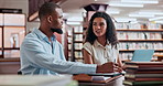 Man, woman and studying in university library for research, education and knowledge in team project. Discussion, students and learning on campus with books, support and help with scholarship at table