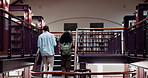 Stairs, walking and man with woman in library for research, college education and knowledge in books. University, students and steps on on campus with bookshelf, learning and studying for scholarship