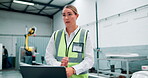 Talking, woman and factory worker with laptop, manufacturing business with thinking employee and solution. Technology, industrial company and reflective vest for safety in engineering warehouse 
