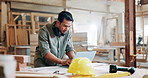 Laptop, carpenter and man in workshop with wood for maintenance, remodeling and construction. Manufacturing, furniture factory and person on computer for website search, typing email and online order