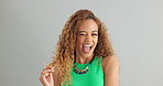Woman, fashion and happy with hair in studio on white background, wink and necklace with trendy outfit. Closeup, female person and excited with colorful top for style, clothes and accessories