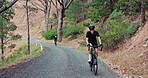 People, mountain and uphill adventure on bicycle for wellness exercise for triathlon training, endurance or workout. Man, bike and cardio challenge as strong athlete with speed, outdoor or fitness