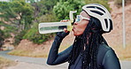Drink, water and woman outdoor for cycling and exercise in morning with bottle for hydration. Triathlon, training and cyclist with enjoy liquid on healthy break for energy on workout in nature