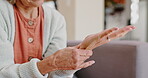 Senior woman, hand pain or injury in living room or couch for relaxing, resting and rubbing for ache relief. Female person, health problem and tension with arthritis or inflammation on sofa at home