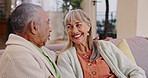 Conversation, funny and senior couple in home living room for communication, story or bonding. Elderly man, happy woman and talking on sofa for love, connection and laughing  together in retirement
