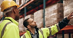 Logistics, man and manager in warehouse pointing, talking and planning inspection for distribution safety. Teamwork, supply chain and people in factory for quality control, partnership and discussion