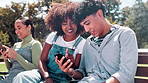 Happy students, bench and laughing with phone for funny joke, entertainment or social media at outdoor park. Friends or people relaxing with smile on mobile smartphone for online browsing in nature