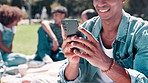 Happy man, student and hands with phone at university for social media, communication or networking in nature. Closeup of young male person with smile on mobile smartphone for online chatting at park