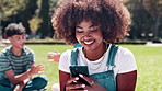 Black woman, student and laughing with phone for social media, communication or networking at outdoor park. African female person with afro, smile or mobile smartphone for online chatting on field