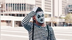 Thinking, mime and man in city with idea scratch head for joke, humor and crazy facial expression. Theatre, street performer and funny man with face paint for performance, entertainment and comedy