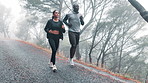 Training, running and couple with fitness, exercise and rain with wellness and healthy with nature. Endurance, outdoor and wet road with man or woman with athlete and runner with sports and cardio