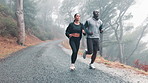 Healthy, running and couple with fitness, exercise and rain with wellness and training with endurance. Cardio, outdoor and wet road with man and woman with a hobby and runner with sports and progress