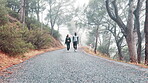 Couple, fitness and walking together in outdoor nature for adventure trail, exercise and wellness. Forest, black man and happy partner for healthy body, cardio workout and explore in morning