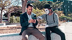 Businessmen, smartphone and irritated with street mime in downtown to search location or navigate New York. Entrepreneur, cellphone and typing to browse internet or online conversation in outdoor