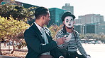 Businessmen, phone call and cellphone with street mime in downtown New York for conversation. Entrepreneur, men and artistic in outdoor with smartphone for communication in city with funny face musk 
