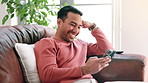 Phone, laughing and man on sofa at his home networking on social media, mobile app or internet. Happy, typing and person read comic, funny or comedy joke online with cellphone in living room at house