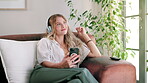 Couch, headphones and woman with phone  to relax  for music, listening and smile on sofa for peace. Technology, girl and female person in living room with mobile for streaming with internet in home