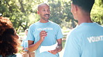 Man, documents and volunteer with team in nature for discussion, planning or outdoor schedule at park. Male person, group or young coworkers talking with paperwork for NGO, support or tasks in forest