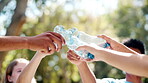 Volunteers, hands and bottles with unity, nature and environmental care for cleanup. NGO, team and support for sustainable, recycling and green collaboration for charity service or earth day project