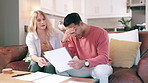 Stress, finance and couple with documents on sofa for mortgage loan, insurance or debt in living room. Savings, frustrated man and woman with paperwork for budget, tax audit or inflation in home