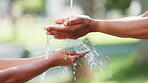 Splash, pour and water on hands outdoors for hydration or cleanliness, wash and wellness in environment. Liquid, h2o and streaming or flow for sustainability or refreshing with nature on earth day.