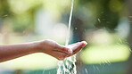 Splash, pour and water on hands in nature for hydration or cleanliness, wash and wellness in environment. Liquid, h2o and streaming or flow for sustainability or refreshing outdoors on earth day.