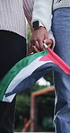 People, holding hands and flag of Palestine with support for human rights, activism and partnership. Friends, alliance and collaboration in park for genocide, freedom and hope for peace in Gaza