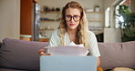 Living room, laptop and woman with stress of bills, paper and anxiety for payment of house. Apartment, home and female person with glasses on sofa or couch with receipt of balance of mortgage or loan