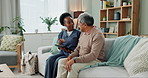 Tablet, healthcare and black nurse in home by senior man, internet and communication on wellness on sofa. African caregiver, elderly person and technology for learning and help in chronic illness