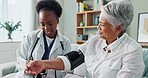 Senior, woman and doctor with monitor for blood pressure with hypertension diagnosis, medical test and cardiovascular. Elderly patient, nurse and discussion in nursing home for healthcare assessment