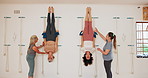 Stretching, fitness and rope on wall for yoga with senior group or people practice iyengar together in gym class. Women, body health and friends help for wellness, exercise and flexibility at club